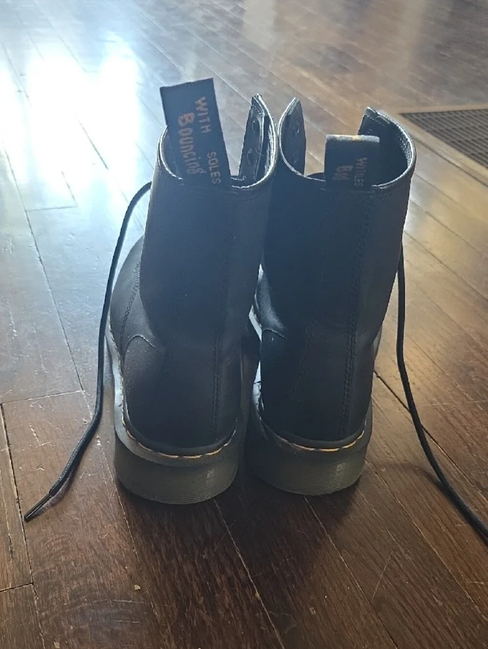 Dr. Martens Black Leather 8-Eye Lace-Up Boots with Yellow Heel Loop